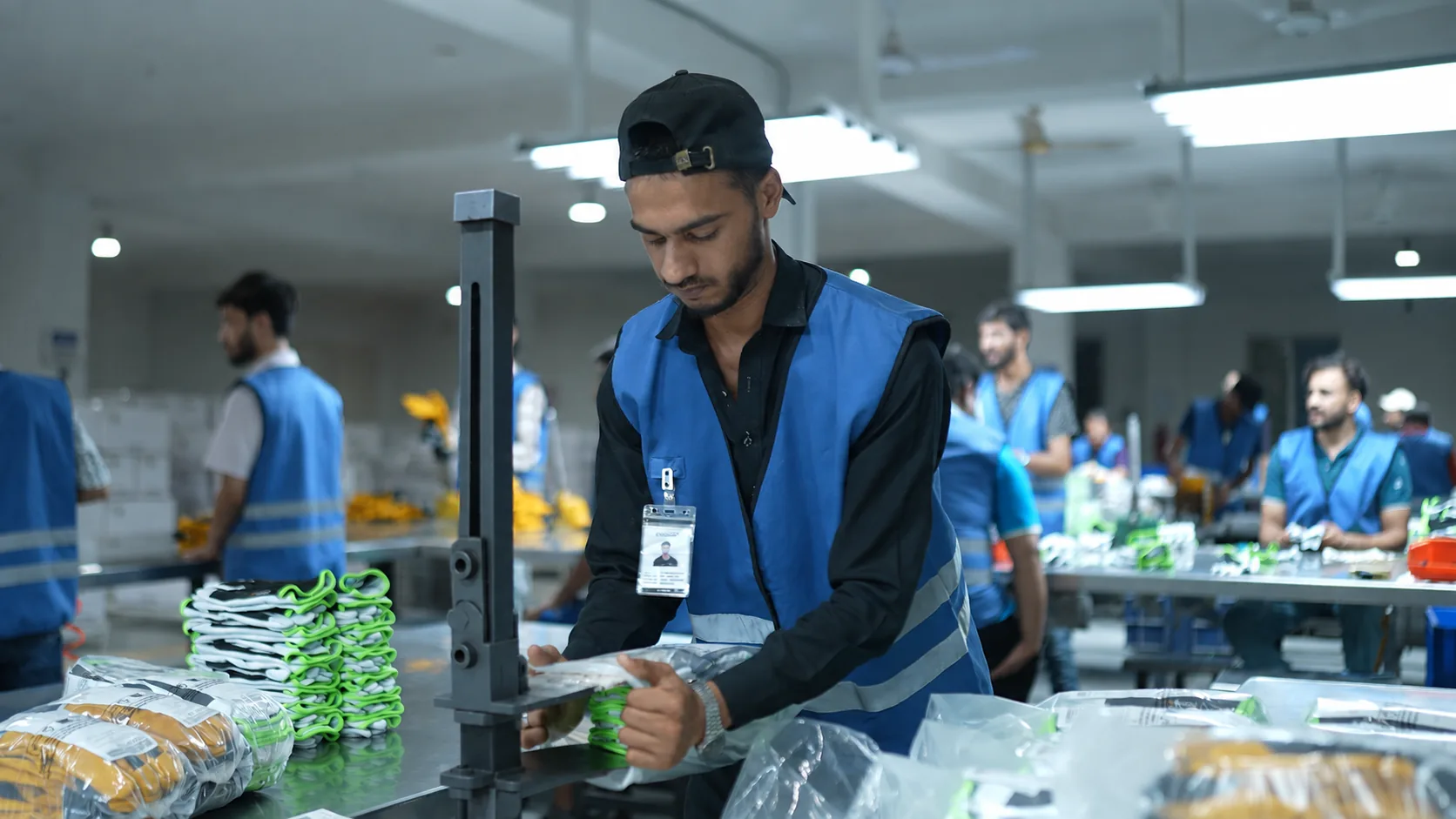 Worker packaging protective gloves on the production floor
